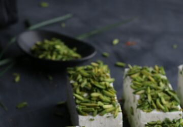 From above of similar delicious cake pieces with tender texture decorated with bright crunchy pistachios