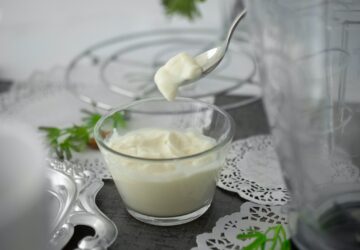 close-up photo of white cream in clear shot glass