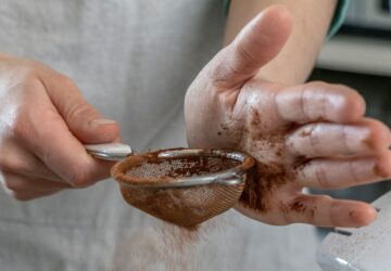 person holding silver round bowl