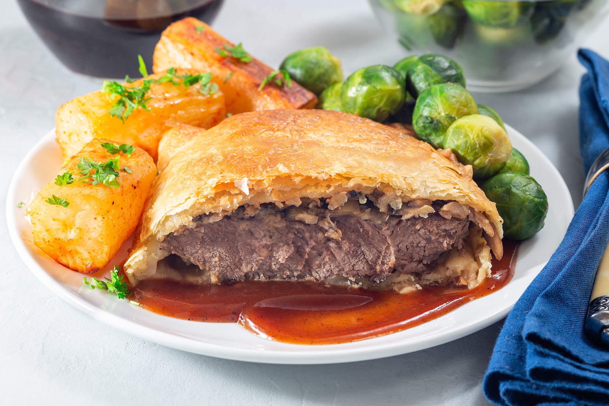 Beef Wellington with mushroom Duxelles, served with brussels sprouts and Chateau potato, horizontal