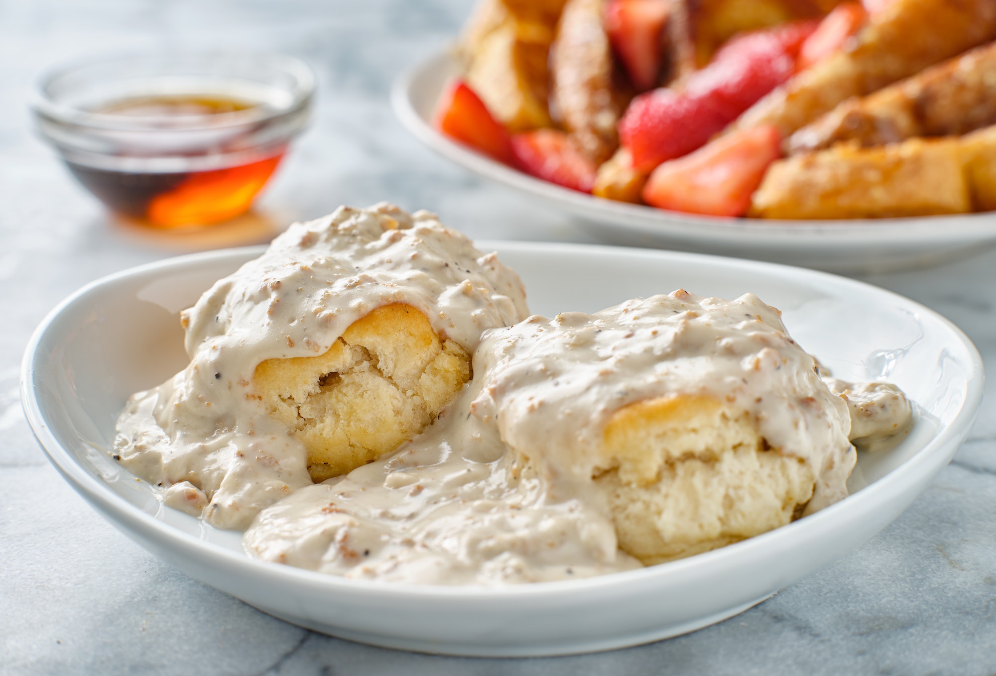 biscuits and gravy with sausage on plate