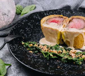 Pork tenderloin en croute on black plate