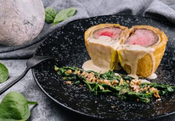 Pork tenderloin en croute on black plate