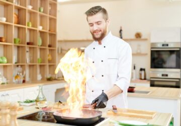 Smiling Chef Cooking Flambe
