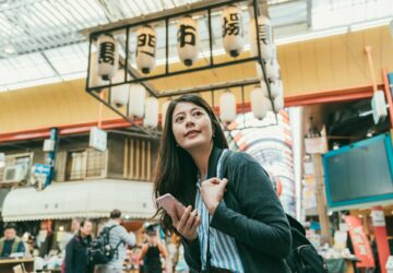 woman enjoying the vibe in kuromon ichiba market